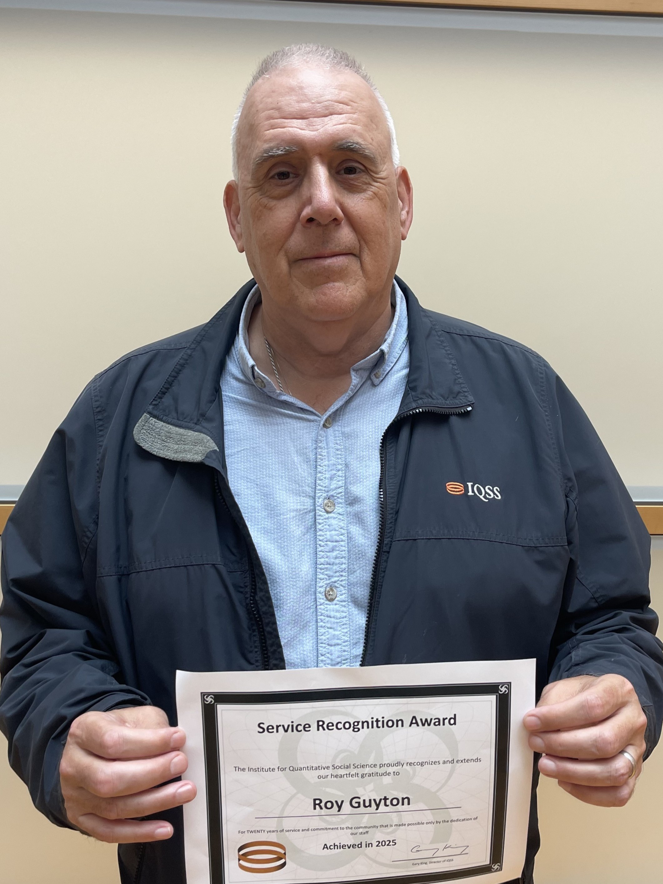 Roy Guyton holding his 20-year service certificate