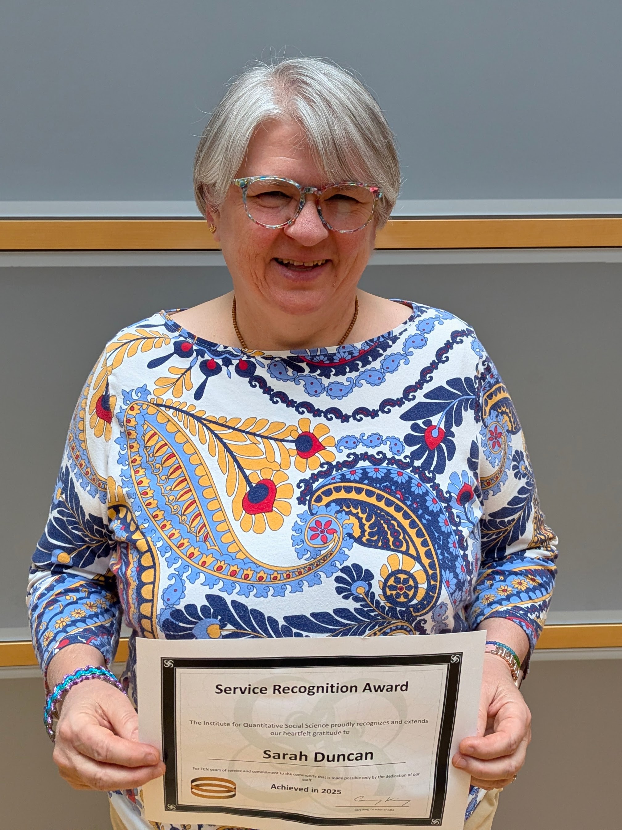 Sarah Duncan holding her service award certificate