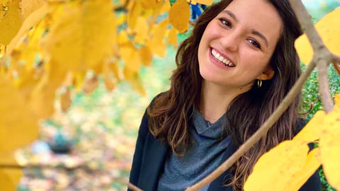 Maria Ballesteros under an autumn tree