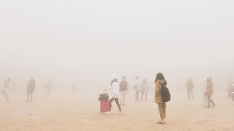 People scattered across a very hazy space