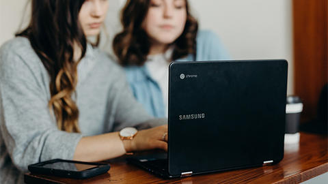 two people at laptop