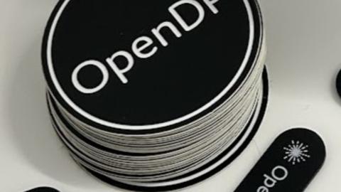 Stack of round stickers with OpenDP logo