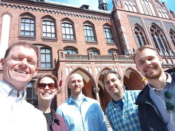 Phil Durbin, Gustavo Durand, and Dataverse LV team members outside a historic building in Riga
