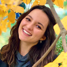 Maria Ballesteros under an autumn tree