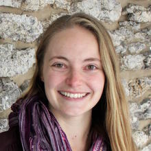 Kaitlyn Chriswell in front of a stone wall