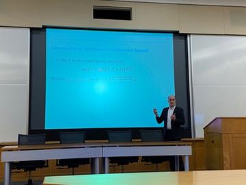 Andrew Mack presenting during a conference session