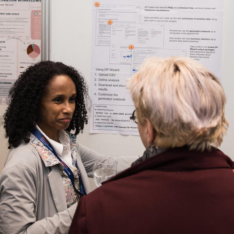 Ceilyn Boyd speaks with a DCM attendee at a poster session