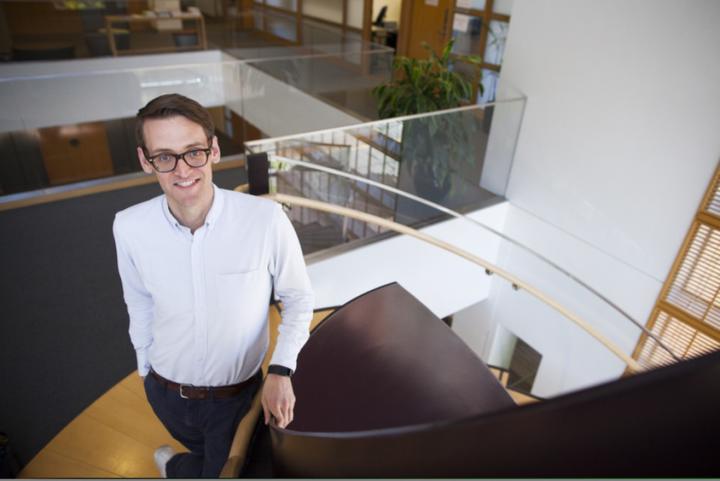 Matt Blackwell standing on the front staircase in CGIS Knafel