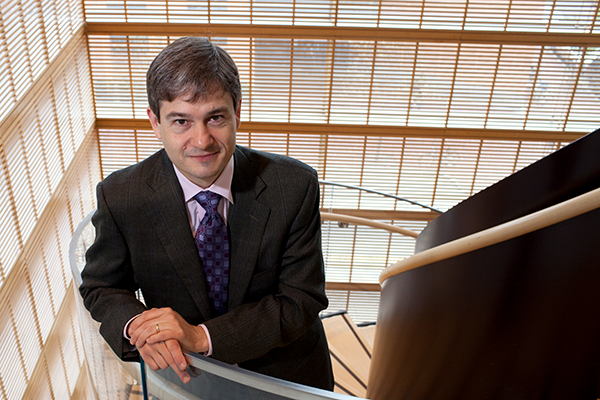 Stephen Ansolabehere standing on the front staircase in the CGIS building