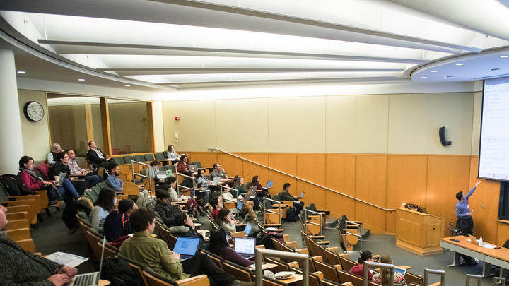 speaker presenting to meeting attendees in Tsai auditorium
