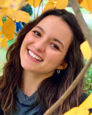 Maria Ballesteros under an autumn tree